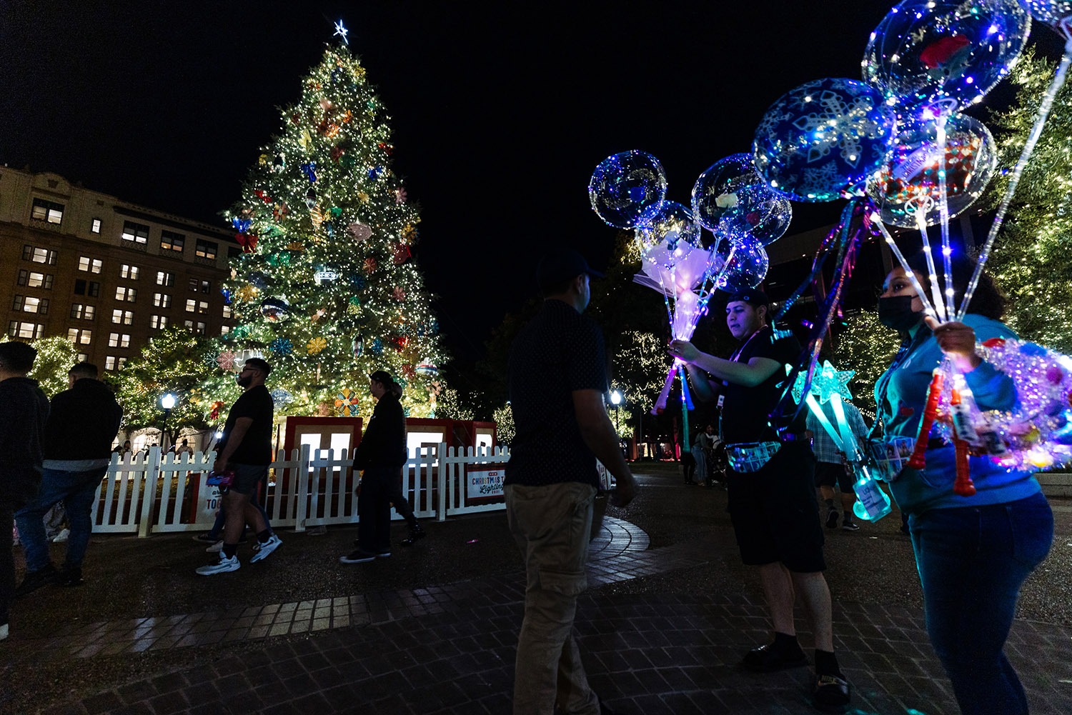 Thousands of people have gathered at Travis Park since the start of the holiday season in San Antonio to take photos in front of the H-E-B Christmas tree, and skate at the Rotary Ice Rink. Dec. 5, 2021. Photo by Chris Stokes | Heron contributor