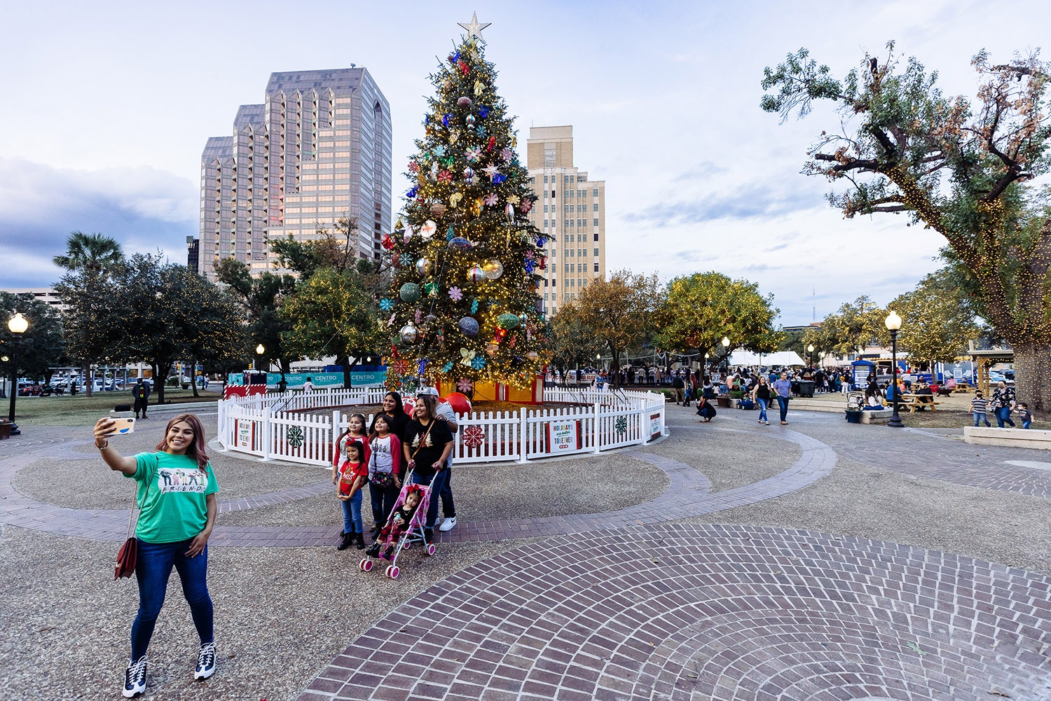 The Vargas family pose for a photo in front of the H-E-B Christmas tree in Travis Park on Dec. 5, 2021. Photo by Chris Stokes | Heron contributor