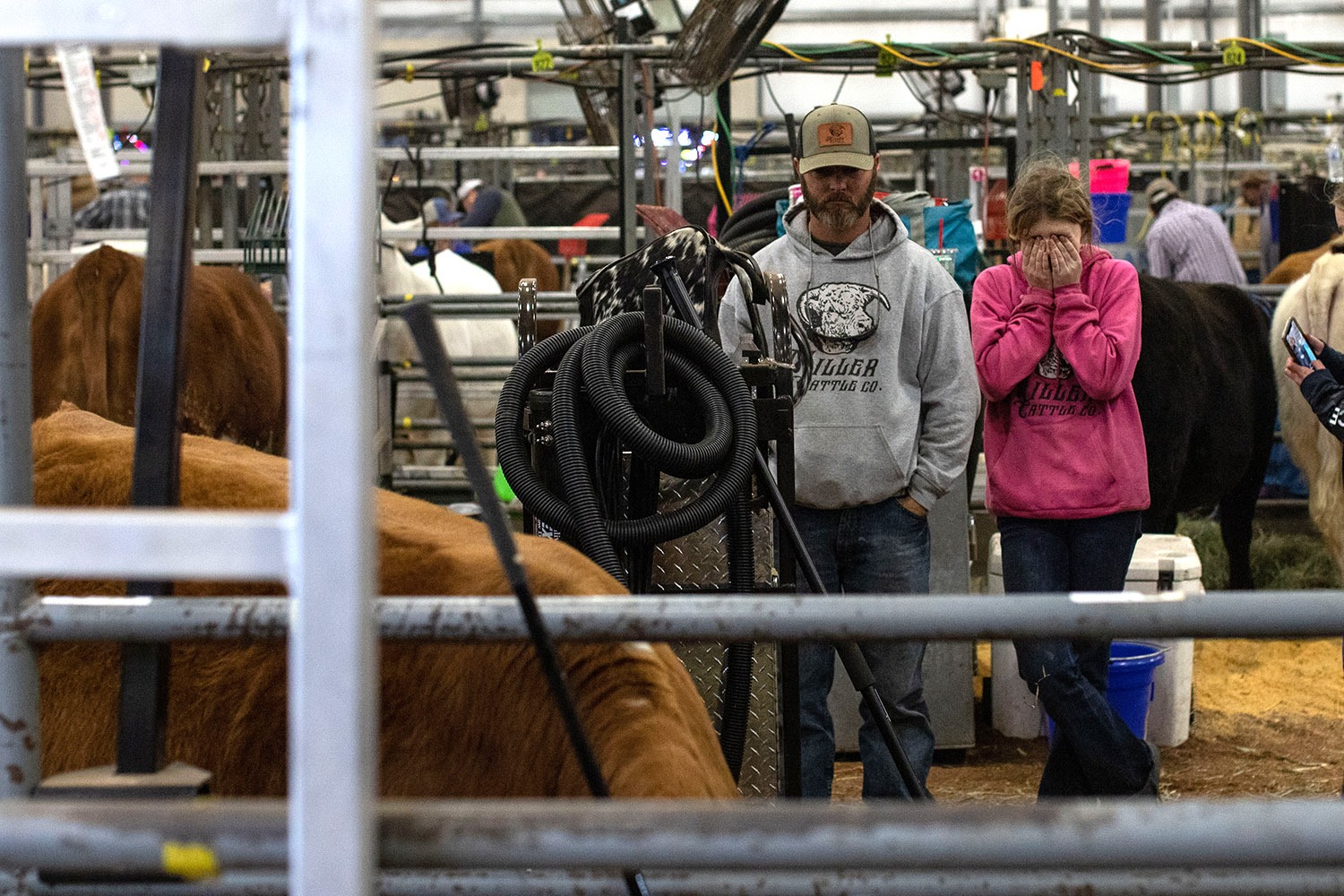 A girl rubs her eyes in the cattle barn at the San Antonio Stock Show and Rodeo on Friday, Feb. 18, 2022. Photo by Kaylee Greenlee Beal | Heron contributor