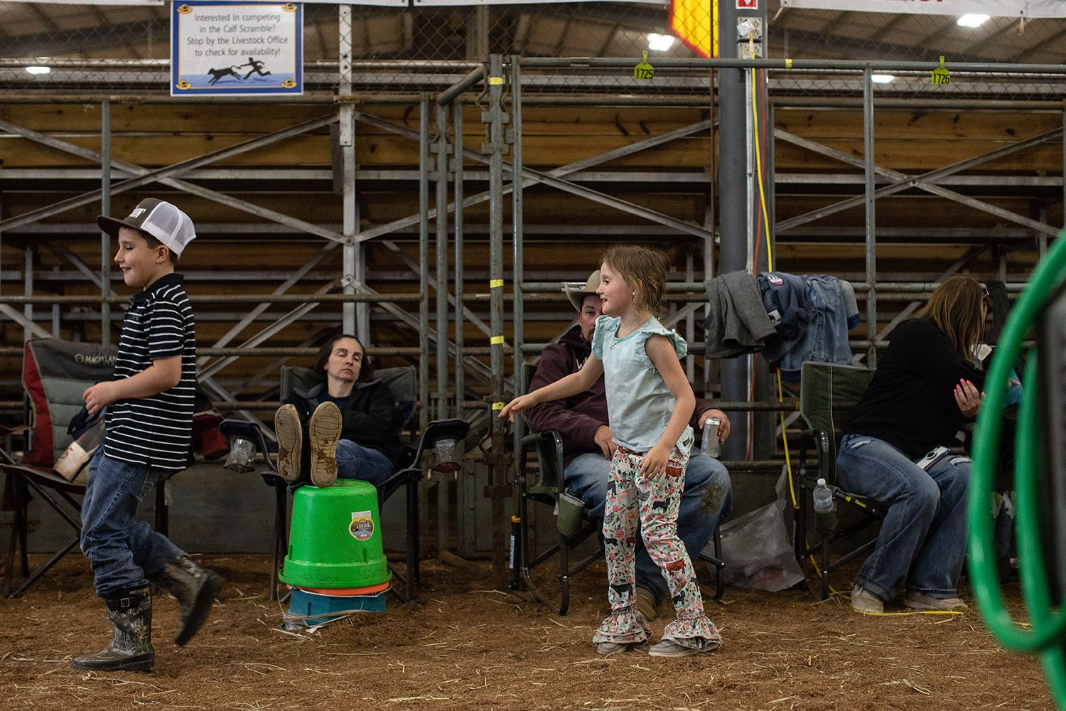 Children play while adults rest in the cattle barn at the San Antonio Stock Show and Rodeo on Friday, Feb. 18, 2022. Photo by Kaylee Greenlee Beal | Heron contributor