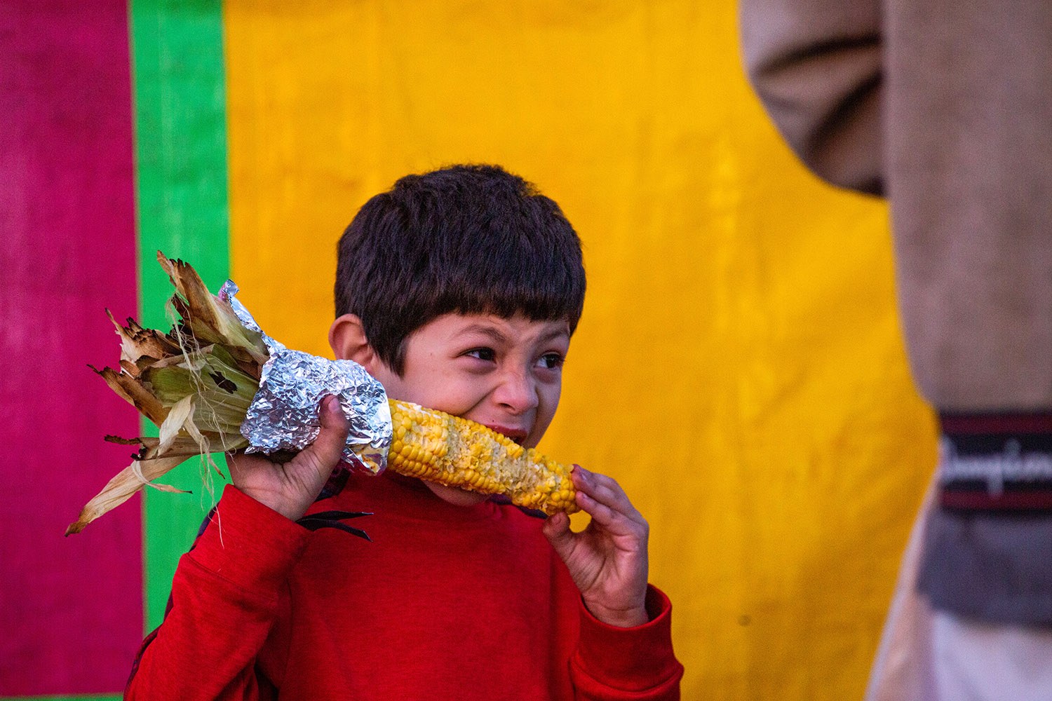 A boy enjoys corn at the San Antonio Stock Show and Rodeo carnival on Friday, Feb. 18, 2022. Photo by Kaylee Greenlee Beal | Heron contributor