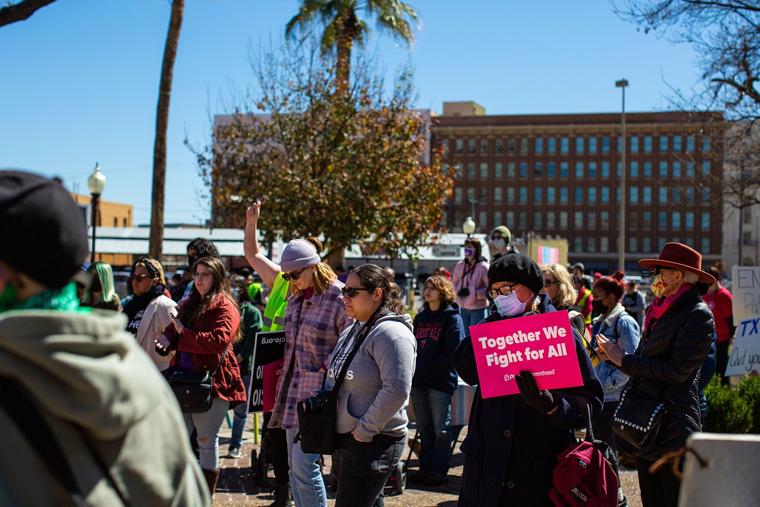Marchers gather Saturday morning, March 12, 2022, at Travis Park before the 32nd San Antonio International Women’s Day March. Photo by Kaylee Greenlee Beal | Heron contributor
