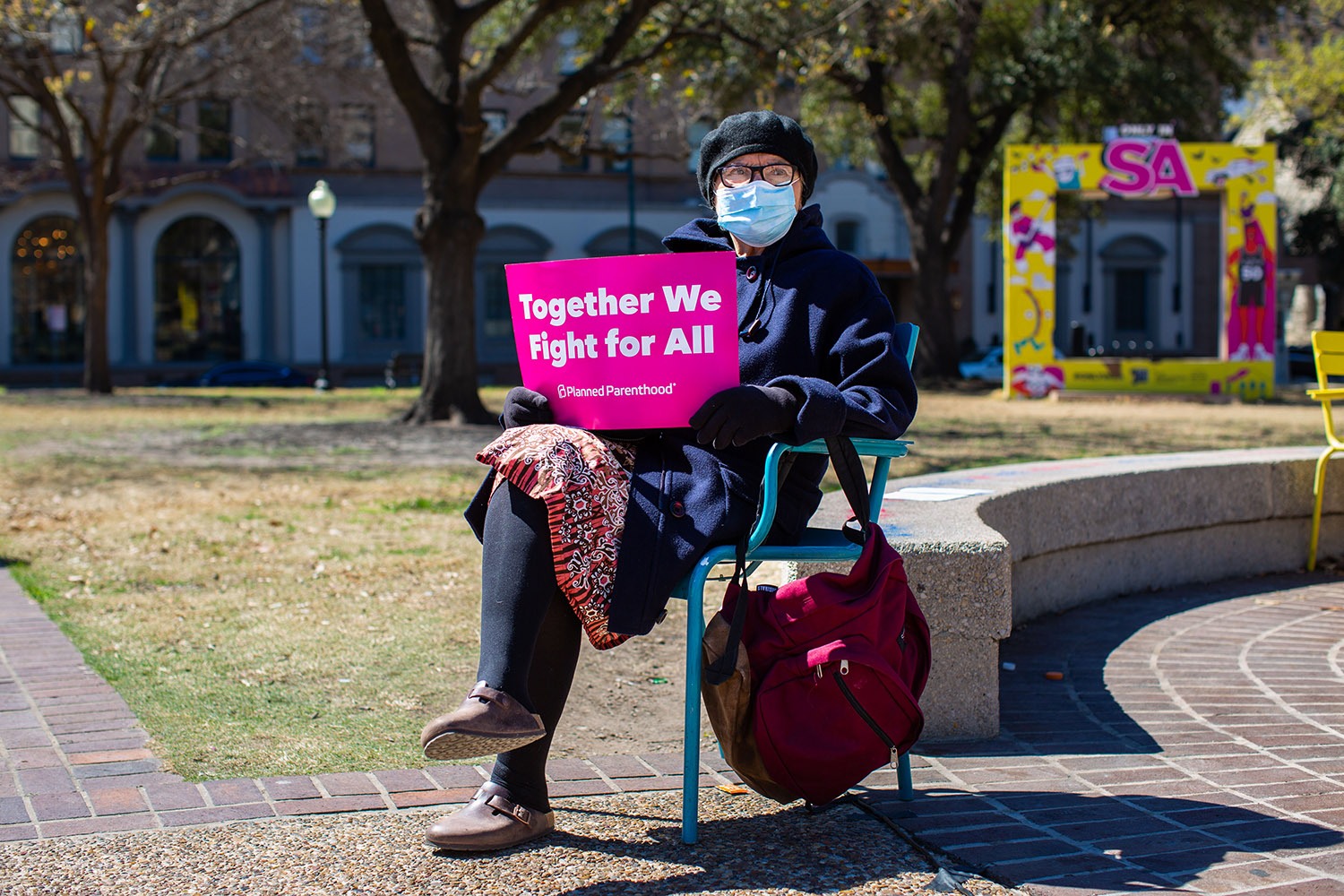 Rebecca Flores joins other marchers Saturday morning, March 12, 2022, at Travis Park before the 32nd San Antonio International Women’s Day March. Photo by Kaylee Greenlee Beal | Heron contributor