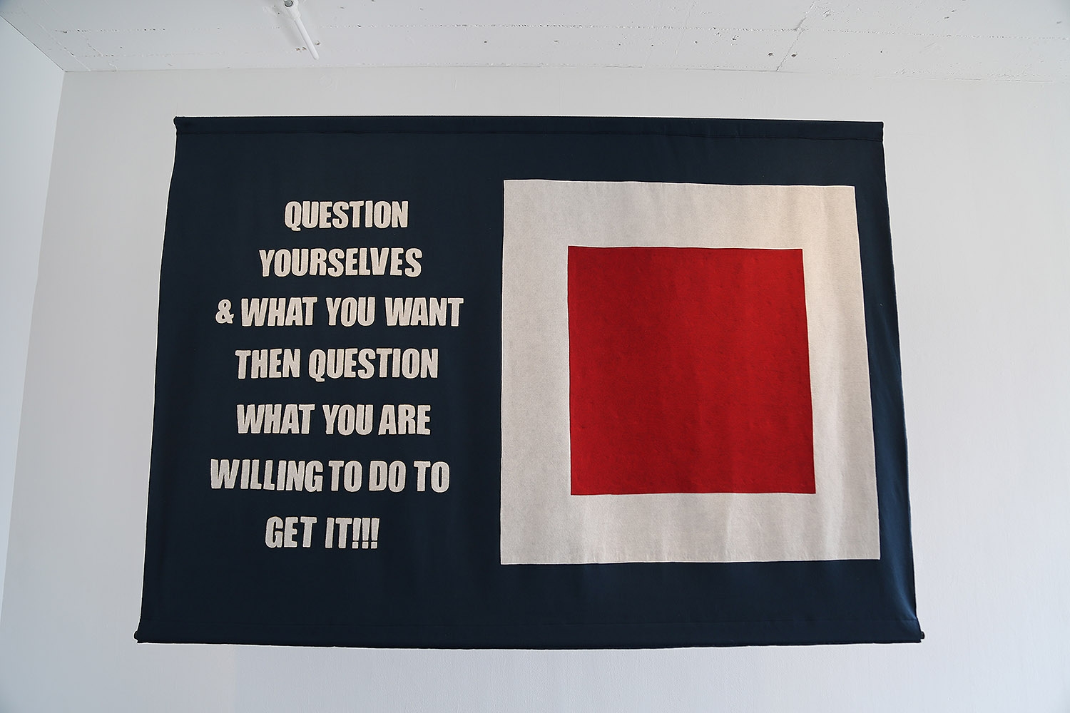 A banner on display in the "Word on the Street" exhibition at Artpace.