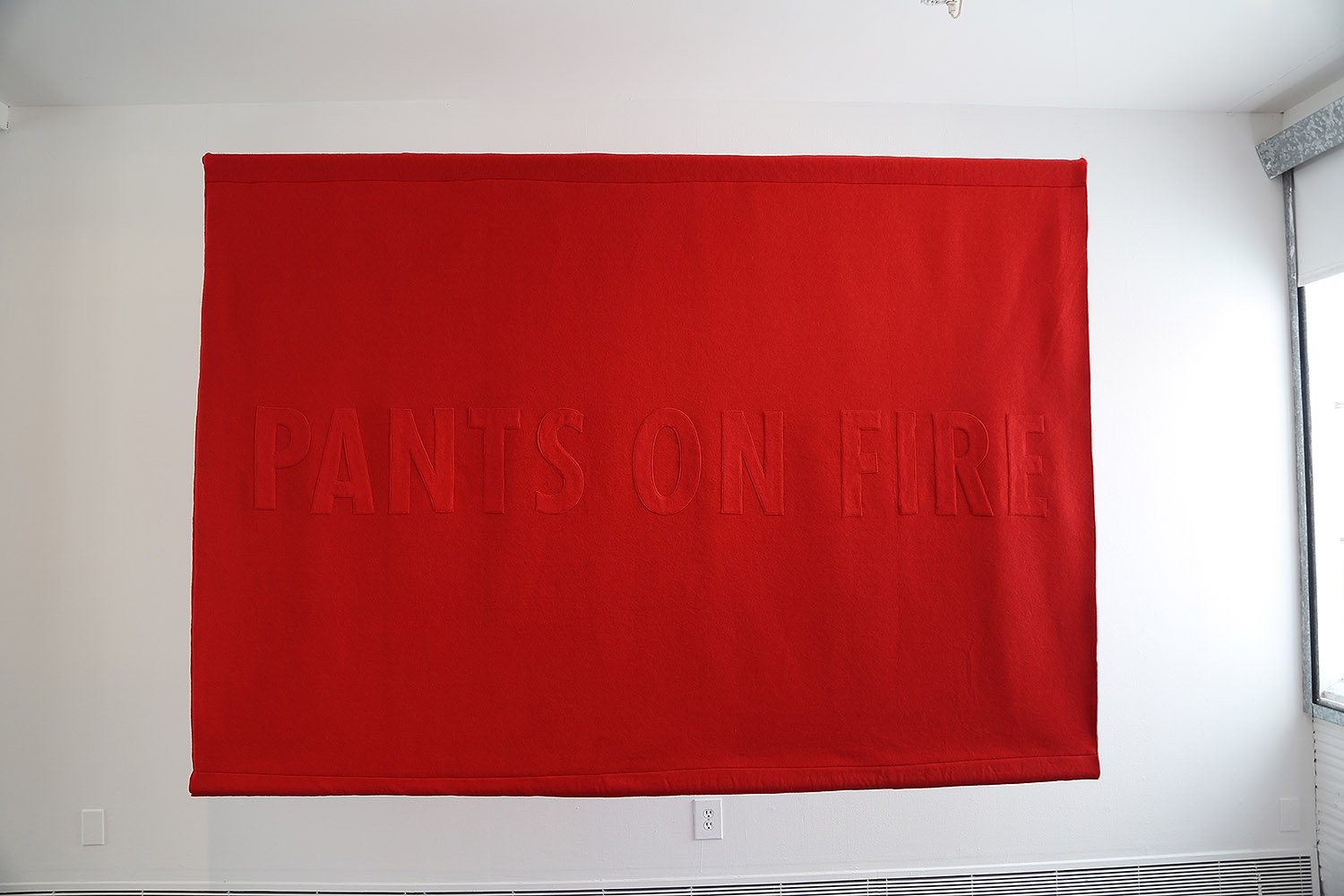 A banner by Jenny Holzer on display in the "Word on the Street" exhibition at Artpace.