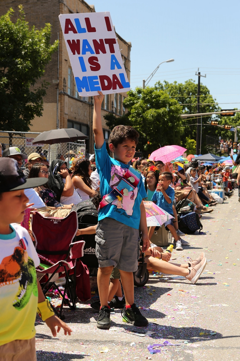 Jonathan Hernandez, 6, has a message for parade-goers at the Battle of Flowers Parade on Friday. Photo by Kara Hawley | Heron contributor