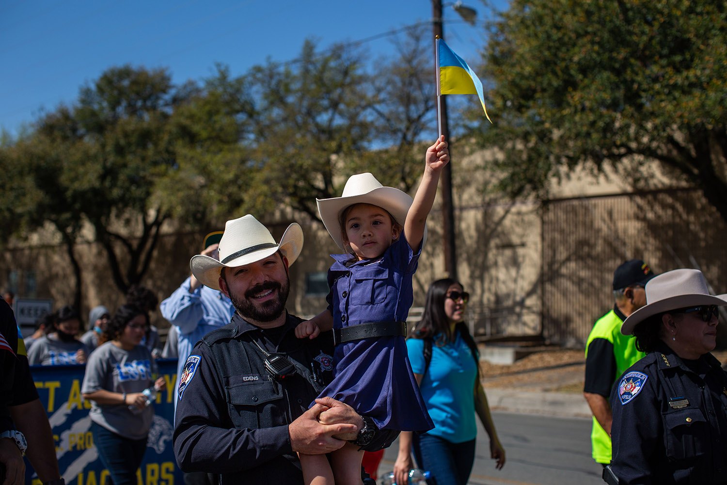 Bexar County Constable Deputy Cory Edens and his daughter, Scarlette, march in the 26th annual Cesar E. Chavez March for Justice through downtown San Antonio, Texas, on Saturday, March 26, 2022. Photo by Kaylee Greenlee Beal | Heron contributor