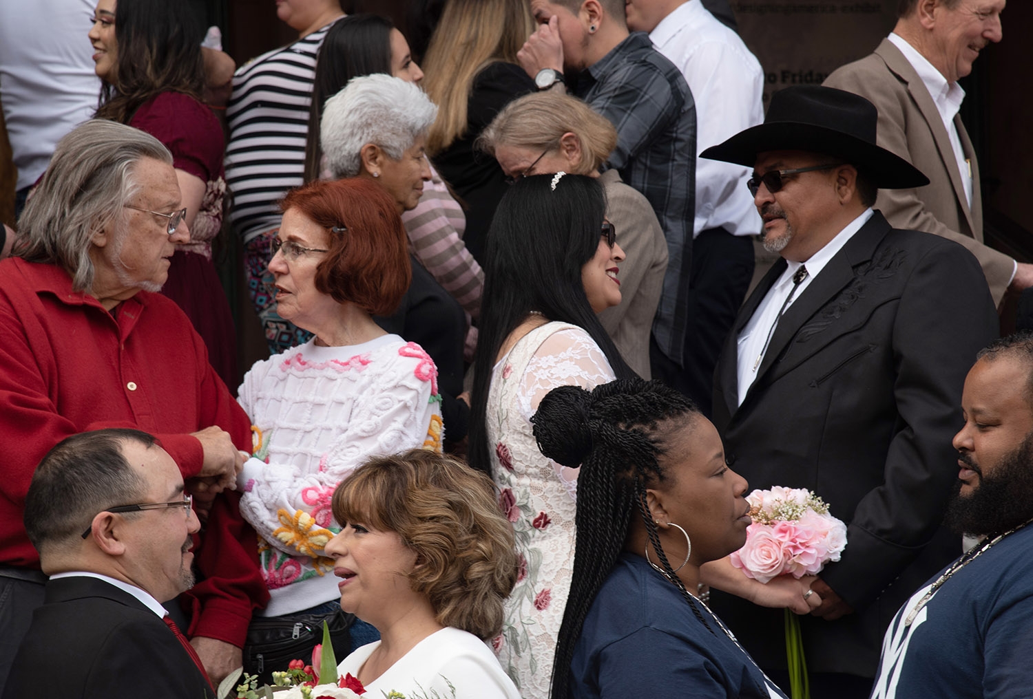 Thirty two couples wait on the Bexar County Courthouse steps to be married at 10 a.m. Feb. 14. <em><b>Photo by V. Finster | Heron</b></em>