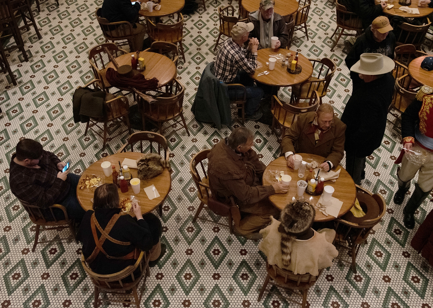 Some individuals who participated in the Dawn at the Alamo ceremony eat breakfast after the event March 6, 2019, at the Buckhorn Saloon.