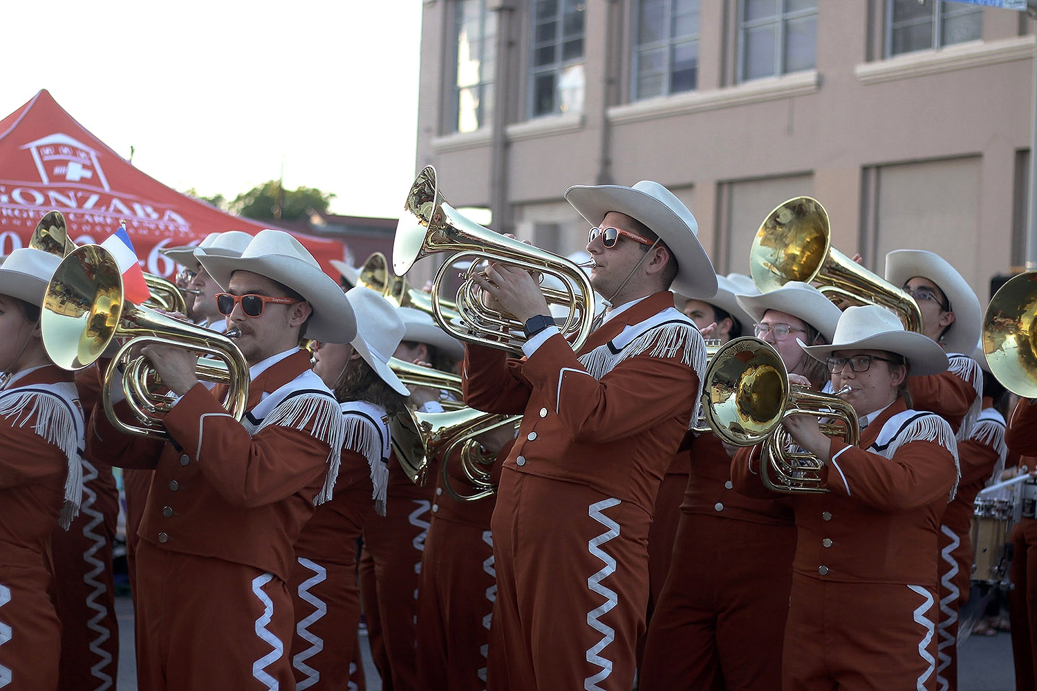 The University of Texas band rolls into the parade with a warm welcome from the crowd during Fiesta Flambeau Saturday night April, 27 2019. <em>Photo by Noah Alcala Bach | Heron contributor</em>