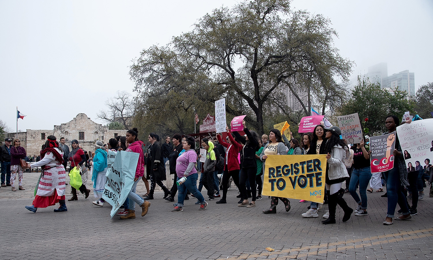 Participants walk in front of the Alamo during the 29th annual San Antonio International Women’s Day March in downtown San Antonio on Saturday, March 2. <b><em>Photo by V. Finster | Heron</em></b>