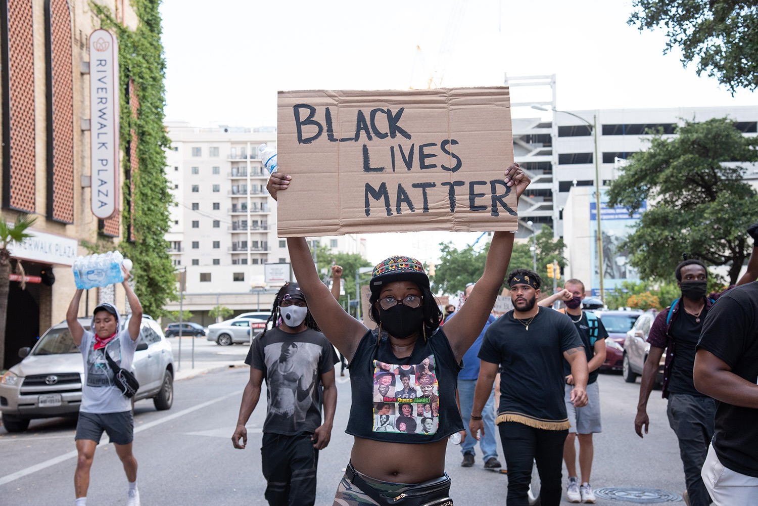 Protestor Nicole Johnson, 28, holds a sign while walking towards the Bexar County Courthouse on Thursday, June 4.Photo by V. Finster | Heron Contributor