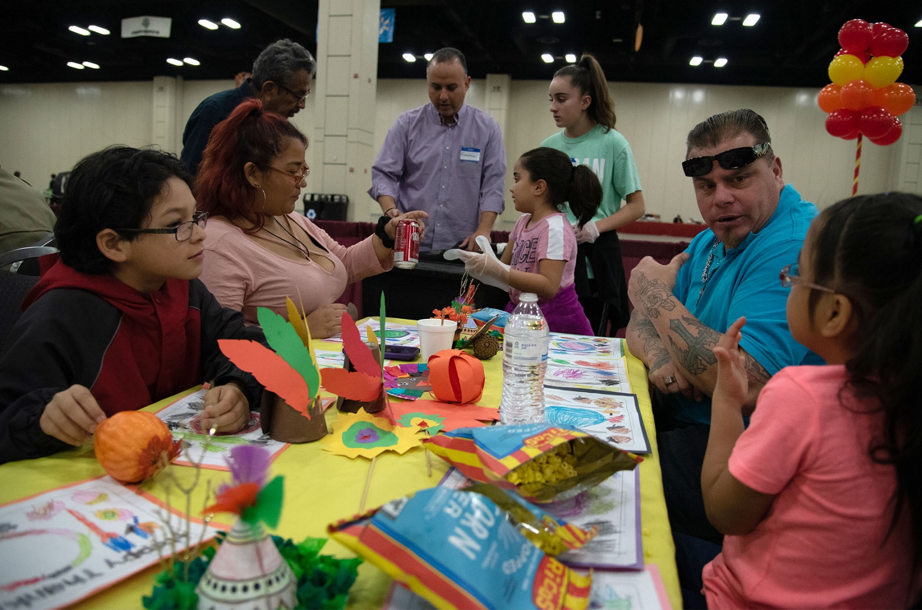 Attendee Jason Quinton asks daughter Alyssa Quiton what she would like to drink during the Raul Jimenez Thanksgiving Dinner Thursday. <em><b>Photo by V.Finster | Heron</b></em>