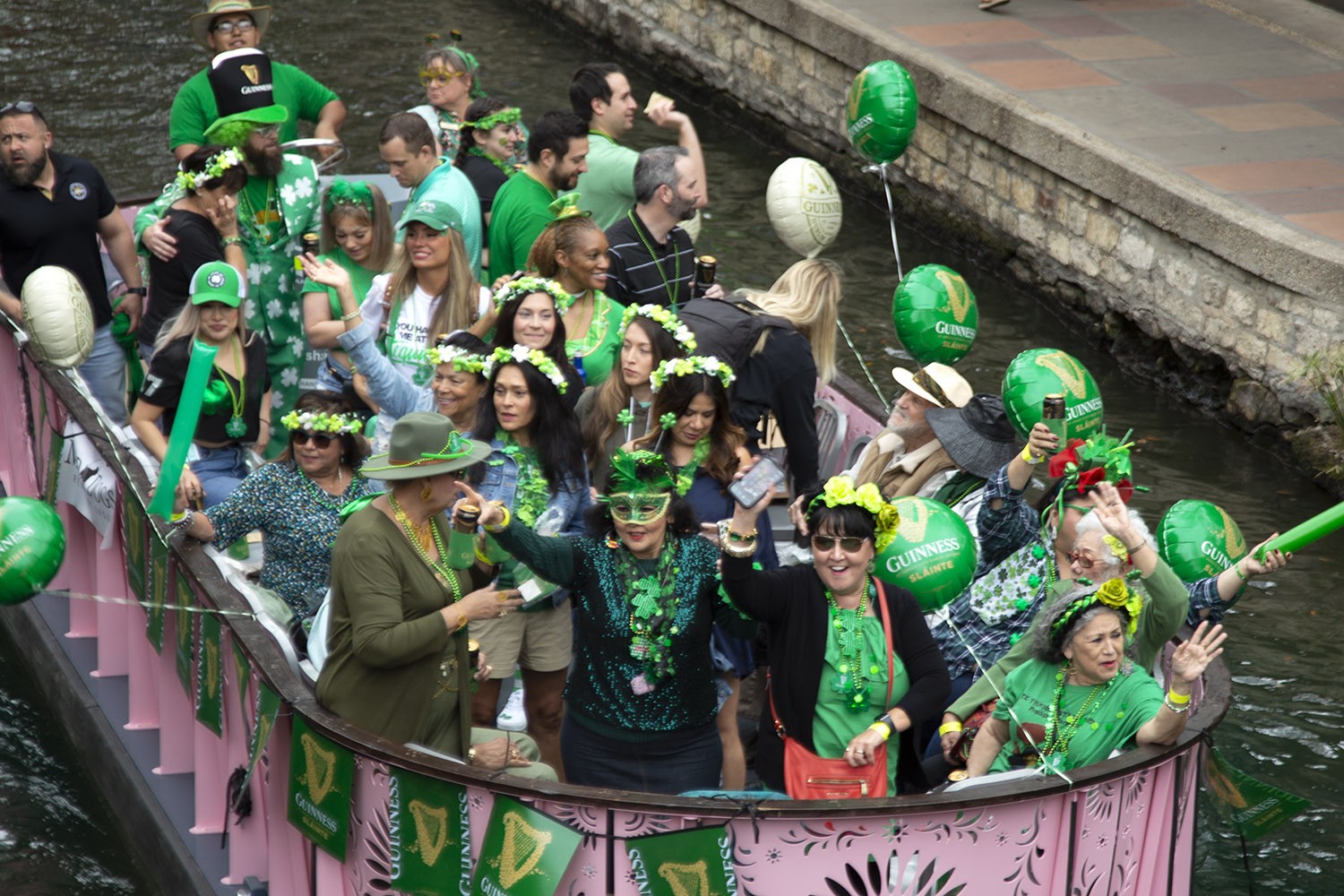 Thousands of people gather along the River Walk on St. Patrick's Day, March 17, 2022, for the annual dyeing of the San Antonio River. Photo by Ben Olivo | Heron
