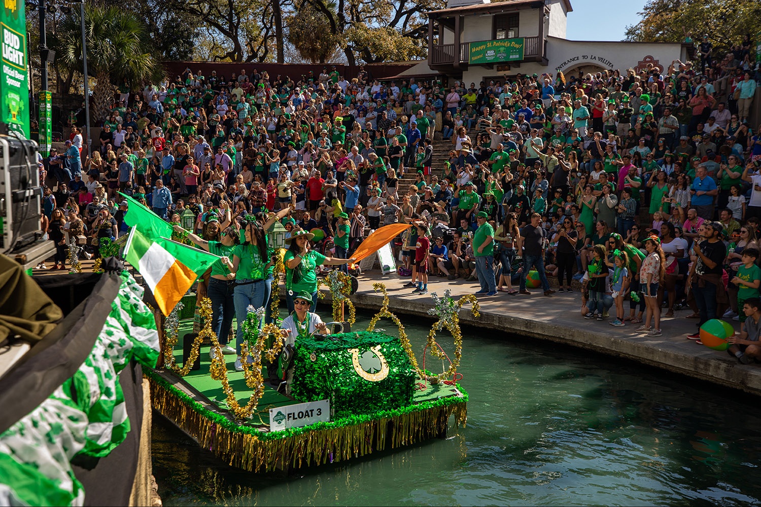 Several decorated floats parade through the River Walk in San Antonio, Texas, during a St. Patrick's Day-themed river parade sponsored by Visit San Antonio River Walk and the Harp & Shamrock Society of Texas on Saturday afternoon, March 19, 2022. Photo by Kaylee Greenlee Beal | @kgreenleephoto | Heron contributor