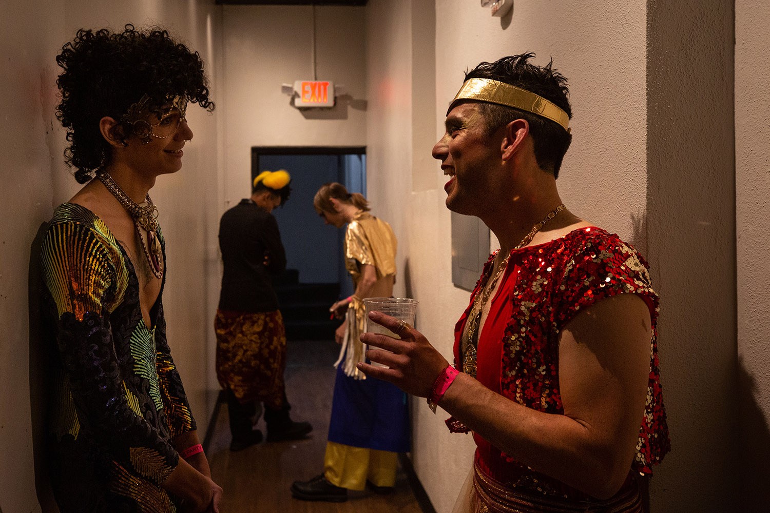 Alejo Peña Soto (left) and Adel Hernandez discuss switching accessories before walking in a fashion show wearing designs by Augusto Cuellar during a fashion show during the WEBB Party on Friday night, April 1, 2022, at the Aztec Theater in downtown San Antonio, Texas. Photo by Kaylee Greenlee Beal | Heron contributor