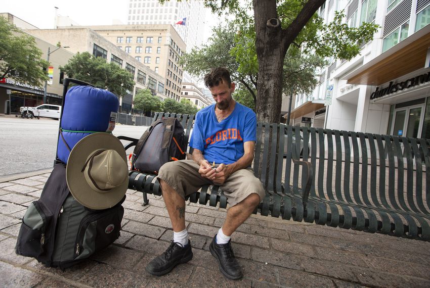 Daniel Johnson, who is homeless, sits on a bench on Congress Avenue in downtown Austin. Photo by Marjorie Kamys Cotera for The Texas Tribune