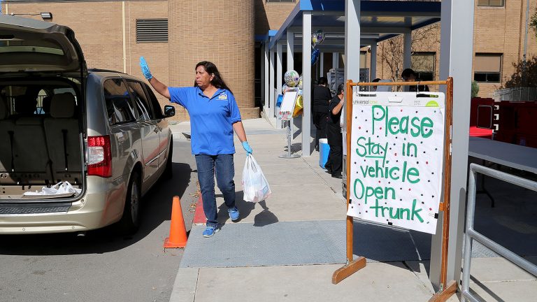 Maria Alonso, a substitute teacher at J.T. Brackenridge Elementary on the near West Side, loads free meals to parents on Wednesday, April 1, 2020.