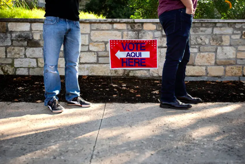 Voters wait in line at a polling site at Austin Oaks Church during early voting.