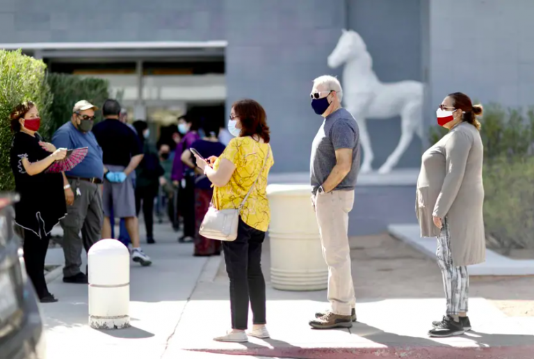 Voters wait in line to cast their ballots at the Sunland Park Mall in El Paso on the first day of early voting.