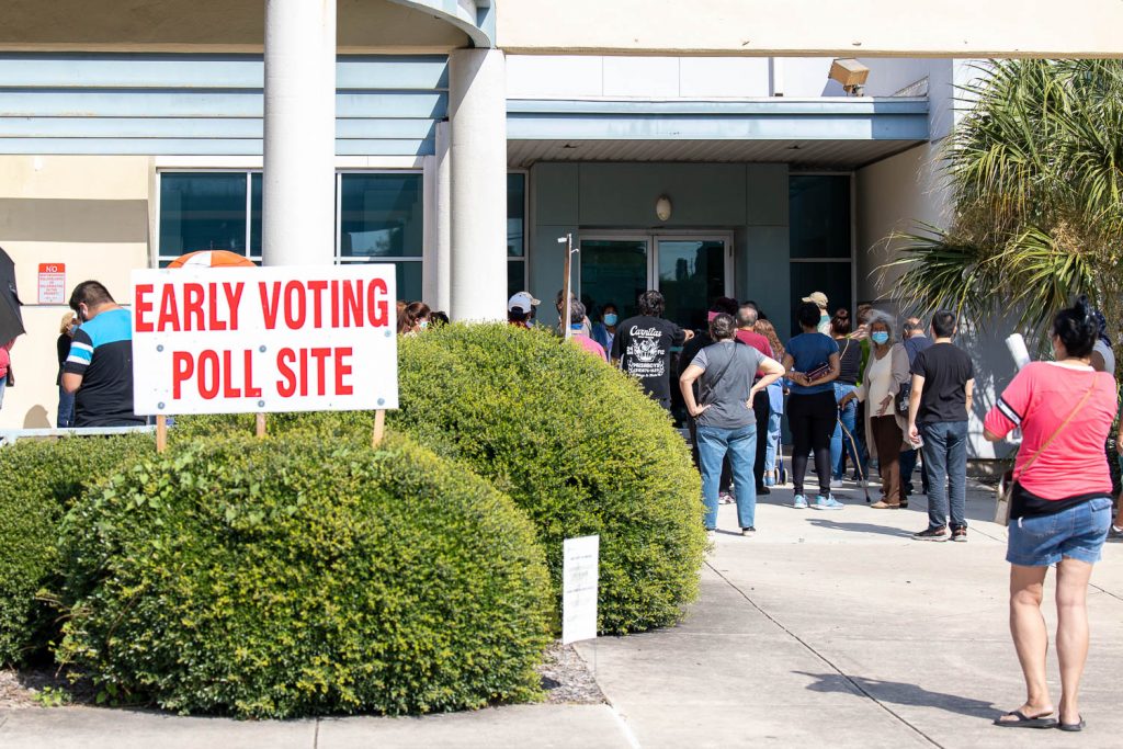 People wait in line at Las Palmas Library on the West Side as early voting began on Tuesday, Oct. 13, 2020.
