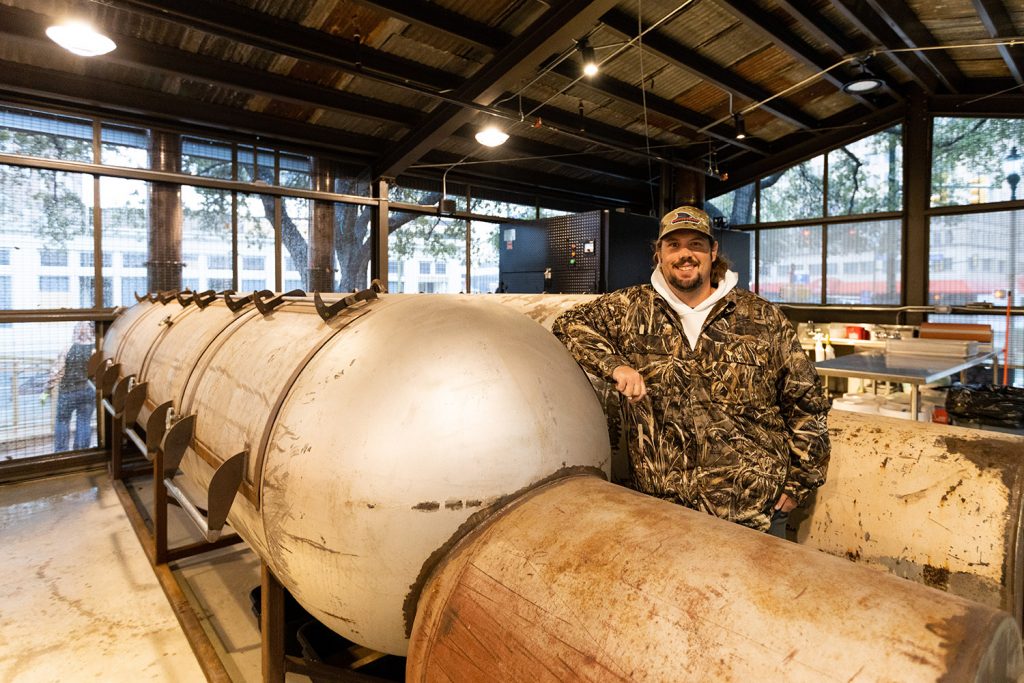 Grant Pinkerton, owner of Pinkerton's Barbecue, poses for a photo inside the pit room of his new restaurant at Weston Urban park.