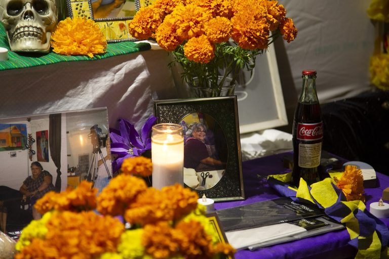 An altar by Blanca Rivera honors her friend Angie Merla, who was a volunteer at the Esperanza Peace & Justice Center, during the center's annual Día de los Muertos event at the Rinconcito de Esperanza arts hub on the West Side.