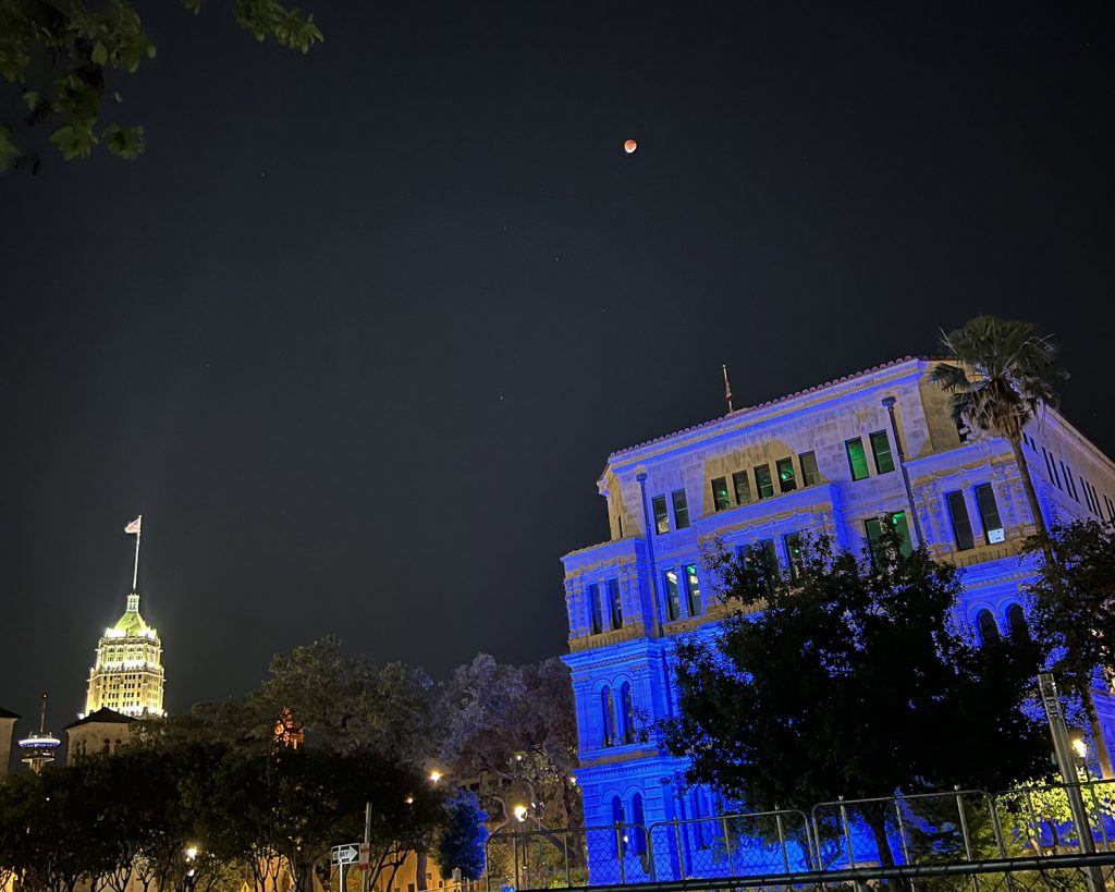 A total lunar eclipse, aka the red blood moon, hangs above downtown San Antonio, Texas, on Sunday night, May 15, 2022.